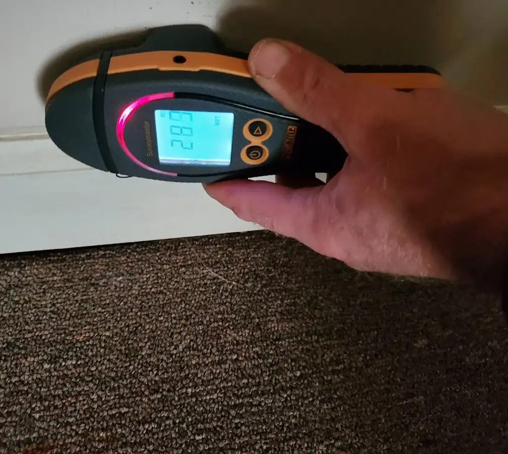 Moisture detection at baseboard during Storm Damage Restoration in Charlestown